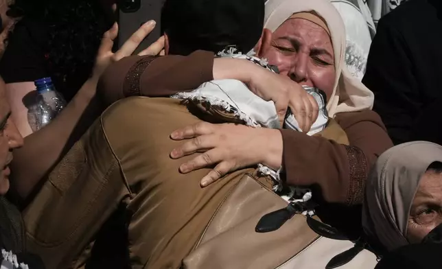 Palestinian prisoners are greeted after being released from Israeli prison following a ceasefire agreement between Israel and Hamas, in the West Bank city of Ramallah, Monday, Oct. 13, 2025. (AP Photo/Mahmoud Illean)