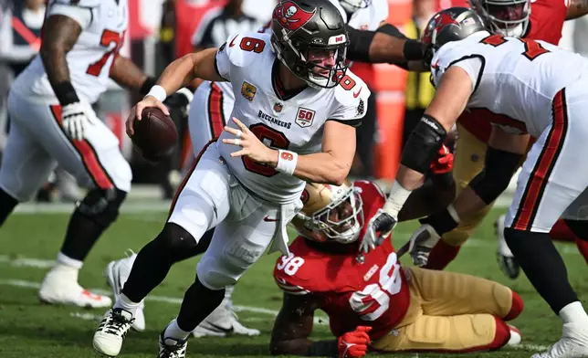 Tampa Bay Buccaneers quarterback Baker Mayfield (6) rolls out against the San Francisco 49ers during the first half of an NFL football game in Tampa, Fla., Sunday, Oct. 12, 2025. (AP Photo/Jason Behnken)