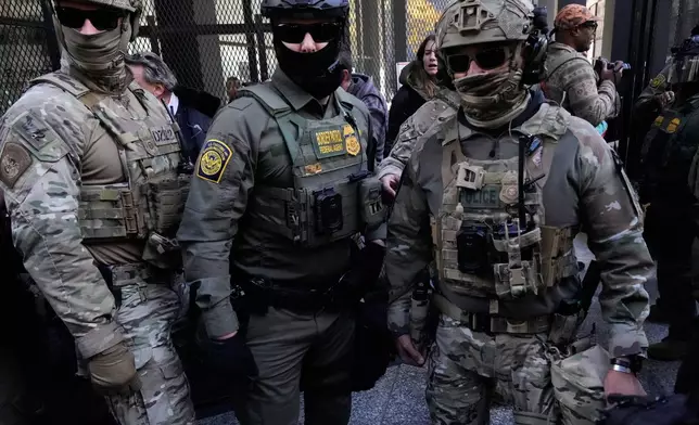 U.S. Customs and Border Patrol agents arrive to escort U.S. Customs and Border Patrol Gregory Bovino from federal court in Chicago, Tuesday, Oct. 28, 2025. (AP Photo/Nam Y. Huh)