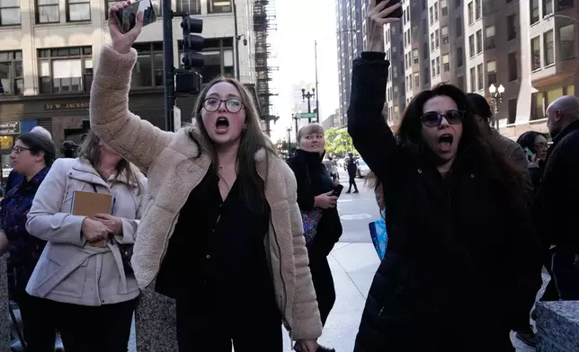 Protesters yell towards U.S. Customs and Border Patrol Gregory Bovino when he leaves federal court in Chicago, Tuesday, Oct. 28, 2025. (AP Photo/Nam Y. Huh)