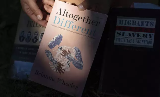 Brianna Wheeler holds her book "Altogether Different" as she poses for photos at Peninsula Park, Monday, Sept. 22, 2025, in Portland, Ore. (AP Photo/Jenny Kane)
