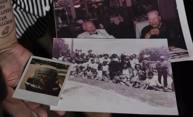 Brianna Wheeler holds family photos, including an image of her grandmother, top right, as she poses for photos at Peninsula Park, Monday, Sept. 22, 2025, in Portland, Ore. (AP Photo/Jenny Kane)