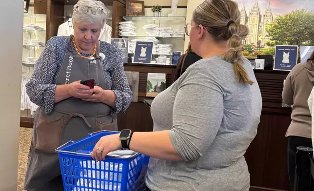 A woman shops for new sleeveless sacred garments worn by members of The Church of Jesus Christ of Latter-day Saints at Deseret Book in Salt Lake City on Tuesday, Oct. 28, 2025. (AP Photo/Hannah Schoenbaum)