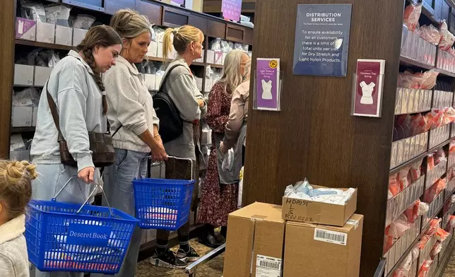 Members of The Church of Jesus Christ of Latter-day Saints shop for new sleeveless sacred garments at Deseret Book in Salt Lake City on Tuesday, Oct. 28, 2025. (AP Photo/Hannah Schoenbaum)