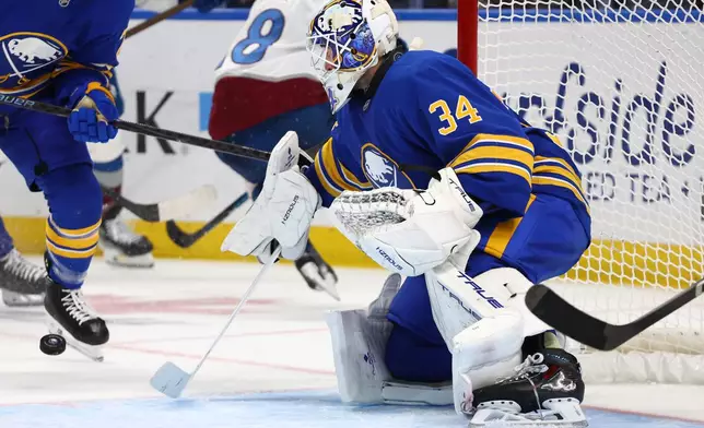 Buffalo Sabres goaltender Alex Lyon (34) watches the puck during the second period of an NHL hockey game against the Colorado Avalanche Monday, Oct. 13, 2025, in Buffalo, N.Y. (AP Photo/Jeffrey T. Barnes)