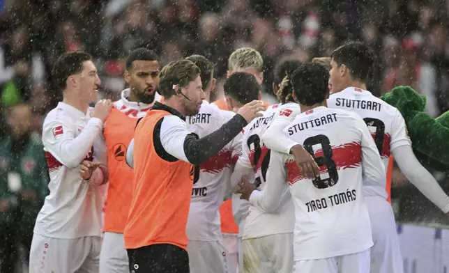 Stuttgart players celebrate Bilal El Khannouss' goal during the Bundesliga soccer match between VfB Stuttgart and 1. FC Heidenheim at MHPArena, Stuttgart, Germany, Sunday Oct. 5, 2025. (Bernd Weissbrod/dpa via AP)