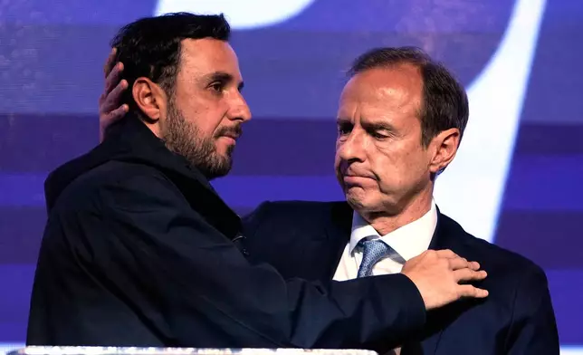 Presidential candidate Jorge "Tuto" Quiroga embraces running mate Juan Pablo Velasco, right, after early results showed them trailing in the presidential runoff election in La Paz, Bolivia, Sunday, Oct. 19, 2025. (AP Photo/Juan Karita)