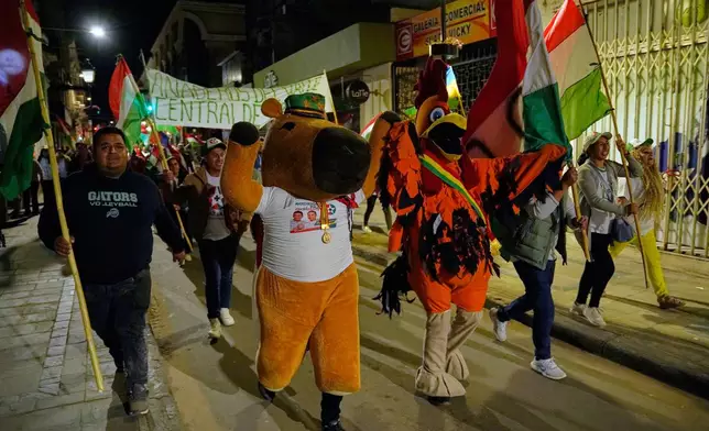 Suppoters of presidential candidate Rodrigo Paz celebrate after early results showed him leading in the presidential runoff election in Tarija, Bolivia, Sunday, Oct. 19, 2025. (AP Photo/Freddy Barragan)