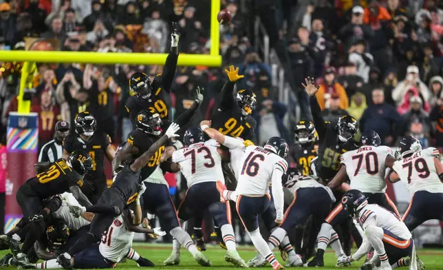 Chicago Bears kicker Jake Moody (16) kicks the game-winning field goal as time expires in an NFL football game against the Washington Commanders, Monday, Oct. 13, 2025, in Landover, Md. (AP Photo/Nick Wass)