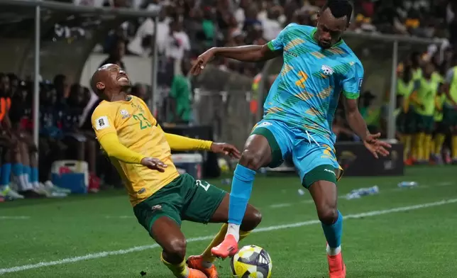 Rwanda's Claude Niyomugabo, right, stops South Africa's Thapelo Morena during a World Cup 2026 group C qualifying soccer match between South Africa and Rwanda at Mbombela Stadium, in Nelspruit, South Africa, Tuesday, Oct. 14, 2025. (AP Photo/Alfonso Nqunjana)