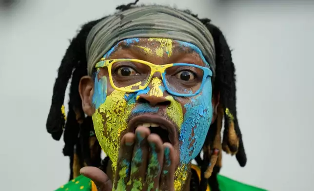 A fan of Rwanda waits for the start of a World Cup 2026 group C qualifying soccer match between South Africa and Rwanda at Mbombela Stadium, in Nelspruit, South Africa, Tuesday, Oct. 14, 2025. (AP Photo/Themba Hadebe)