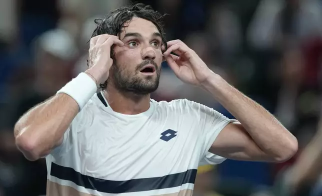 Valentin Vacherot of Monaco reacts after defeating Novak Djokovic of Serbia in the men's singles semifinal match of the Shanghai Masters tennis tournament at Qizhong Forest Sports City Tennis Center, in Shanghai, China, Saturday, Oct. 11, 2025. (AP Photo/Andy Wong)