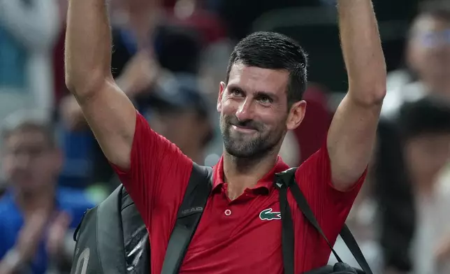 Novak Djokovic of Serbia waves to spectators as he leaves the court after losing his men's singles semifinal match to Valentin Vacherot of Monaco, at the Shanghai Masters tennis tournament at Qizhong Forest Sports City Tennis Center, in Shanghai, China, Saturday, Oct. 11, 2025. (AP Photo/Andy Wong)
