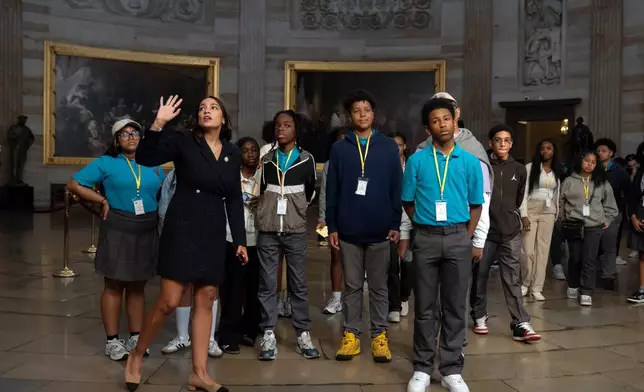 Rep. Alexandria Ocasio-Cortez, D-N.Y., gives a tour of the Capitol to a group of students from New York after their previously-scheduled tour was canceled due to the government shutdown on Wednesday, Oct. 1, 2025, in Washington. (AP Photo/Mark Schiefelbein)