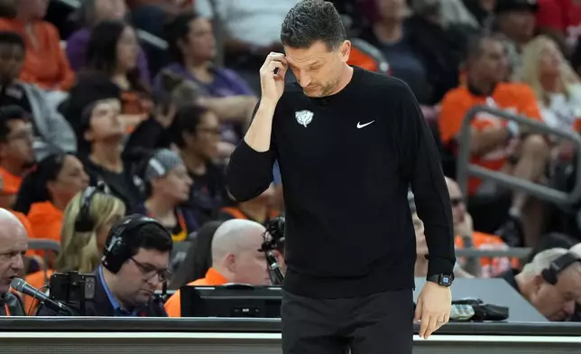 Phoenix Mercury head coach Nate Tibbetts reacts after a play against the Las Vegas Aces during the second half of Game 3 of the WNBA basketball finals, Wednesday, Oct. 8, 2025, in Phoenix. (AP Photo/Rick Scuteri)