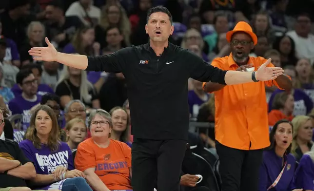Phoenix Mercury head coach Nate Tibbetts reacts after a foul call against the Las Vegas Aces during the first half of Game 4 of the WNBA basketball finals, Friday, Oct. 10, 2025, in Phoenix. (AP Photo/Rick Scuteri)
