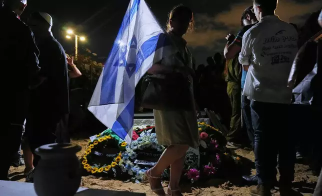 Mourners attend the funeral of slain hostage Eitan Levi after his body was returned from Gaza as part of a ceasefire agreement between Israel and Hamas at Bat Yam cemetery in Holon, Israel, Thursday, Oct. 16, 2025. (AP Photo/Francisco Seco)