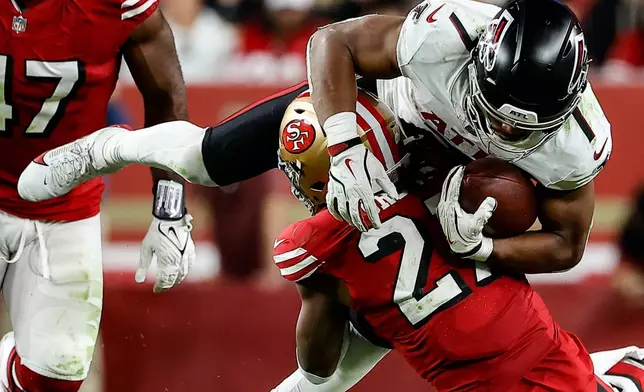 San Francisco 49ers safety Ji'Ayir Brown (27) tackles Atlanta Falcons running back Bijan Robinson (7) in the second half of an NFL football game, Sunday, Oct. 19, 2025, in Santa Clara, Calif. (AP Photo/Kelley L Cox)
