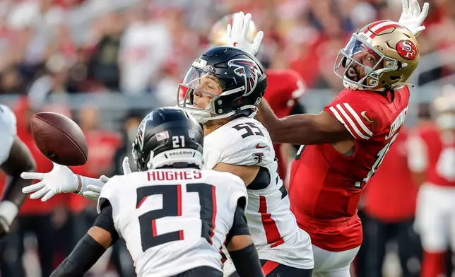 Atlanta Falcons' Kaden Eliss (55) reaches up to intercept a ball bobbled by San Francisco 49ers' Jauan Jennings in the first half of an NFL football game in Santa Clara, Calif., on Sunday, Oct. 19, 2025. (Carlos Avila Gonzalez/San Francisco Chronicle via AP)