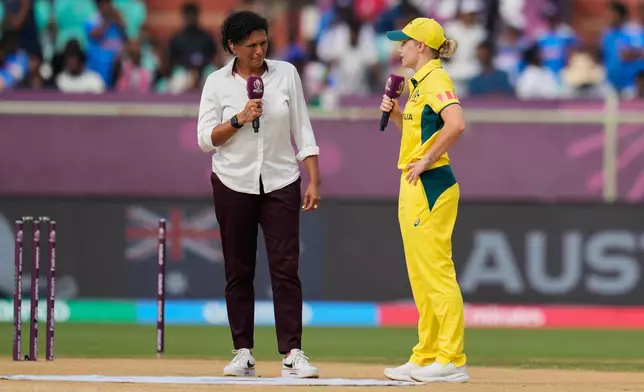 Australia's captain Alyssa Healy, right, speaks to former Australian cricketer and commentator Mel Jones after the coin toss ahead of the ICC Women's Cricket World Cup match between India and Australia at ACA-VDCA Cricket Stadium in Visakhapatnam, India, Sunday, Oct. 12, 2025. (AP Photo/Aijaz Rahi)