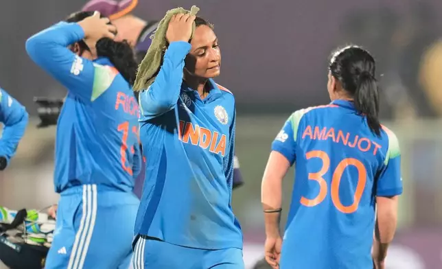 India's captain Harmanpreet Kaur, center, leaves the field after their loss in the ICC Women's Cricket World Cup match against Australia at ACA-VDCA Cricket Stadium in Visakhapatnam, India, Sunday, Oct. 12, 2025. (AP Photo/Aijaz Rahi)