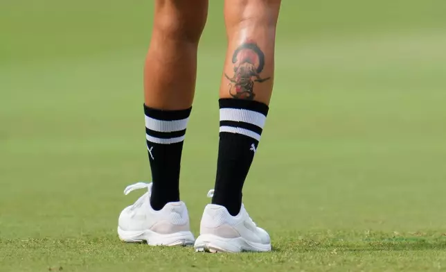 A tattoo is seen on the leg of India's captain Harmanpreet Kaur as she trains ahead of the ICC Women's Cricket World Cup match between India and Australia at ACA-VDCA Cricket Stadium in Visakhapatnam, India, Sunday, Oct. 12, 2025. (AP Photo/Aijaz Rahi)