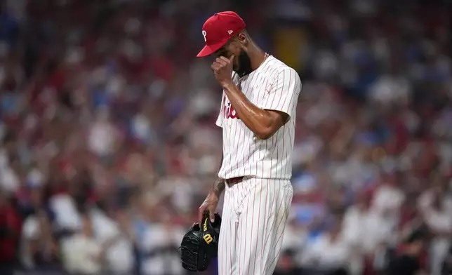 Philadelphia Phillies pitcher Cristopher Sánchez wipes his face after being pulled during the sixth inning in Game 1 of baseball's National League Division Series against the Los Angeles Dodgers, Saturday, Oct. 4, 2025, in Philadelphia. (AP Photo/Matt Slocum)