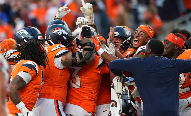 Denver Broncos kicker Wil Lutz (3) is congratulated by teammates after kicking the game winning field goal during the second half of an NFL football game against the New York Giants in Denver, Sunday, Oct. 19, 2025. (AP Photo/David Zalubowski)