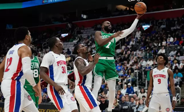 Boston Celtics guard Jaylen Brown, second from right, shoots against, from front left to right, Detroit Pistons forward Tobias Harris, guard Javonte Green, center Jalen Duren and forward Ausar Thompson during the first half of an NBA basketball game Sunday, Oct. 26, 2025, in Detroit. (AP Photo/Ryan Sun)