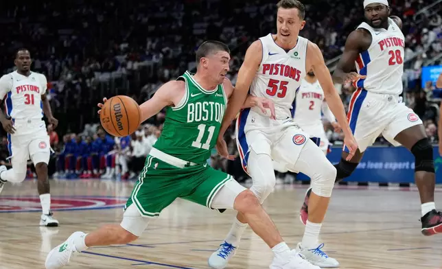 Boston Celtics guard Payton Pritchard (11) drives against Detroit Pistons forward Duncan Robinson (55) during the first half of an NBA basketball game Sunday, Oct. 26, 2025, in Detroit. (AP Photo/Ryan Sun)