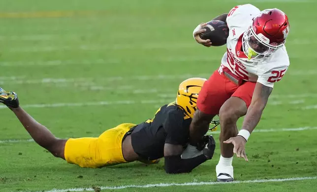 Arizona State defensive back Montana Warren stops Houston running back DJ Butler (25) just short of the endzone during the first half of an NCAA college football game Saturday, Oct. 25, 2025, in Tempe, Ariz. (AP Photo/Ross D. Franklin)
