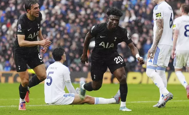 Tottenham Hotspur's Mohammed Kudus, right, celebrates scoring during the English Premier League soccer match at between Leeds United and Tottenham Hotspur at Elland Road, Leeds, England, Saturday Oct. 4, 2025. (Owen Humphreys/PA via AP)