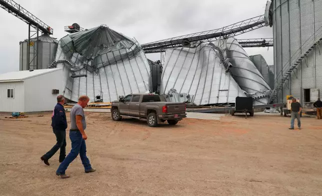 North Dakota Governor Kelly Armstrong walks by silos damaged by an EF5 tornado in Enderlin, N.D., on June 25, 2025. (North Dakota Governor's Office via AP)