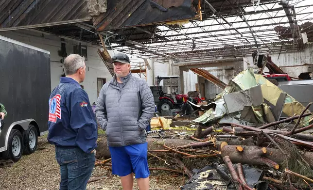 North Dakota Governor Kelly Armstrong speaks with homeowner Tyler Pfaff while surveying tornado damage on June 25, 2025, in Enderlin, N.D. (North Dakota Governor's Office via AP)