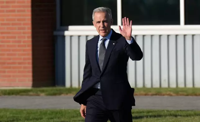 Canada Prime Minister Mark Carney walks to a government plane in Ottawa, Ontario, Monday Oct. 6, 2025. (Adrian Wyld/The Canadian Press via AP)