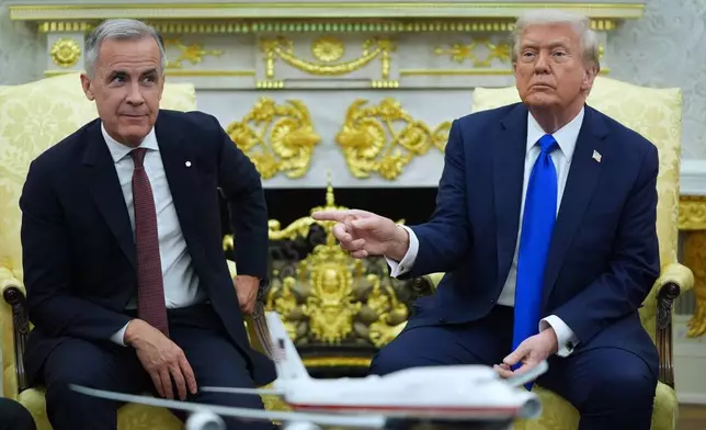 President Donald Trump and Canadian Prime Minister Mark Carney meet in the Oval Office of the White House, Tuesday, Oct. 7, 2025, in Washington. (AP Photo/Evan Vucci)