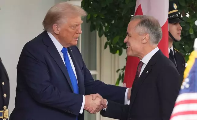 President Donald Trump greets Canadian Prime Minister Mark Carney at the White House, Tuesday, Oct. 7, 2025, in Washington. (AP Photo/Evan Vucci)