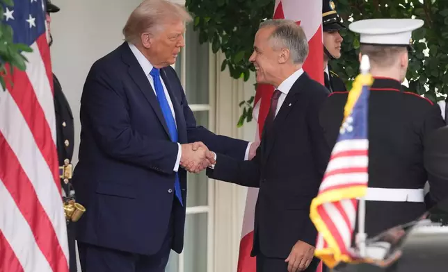 President Donald Trump greets Canadian Prime Minister Mark Carney at the White House, Tuesday, Oct. 7, 2025, in Washington. (AP Photo/Evan Vucci)