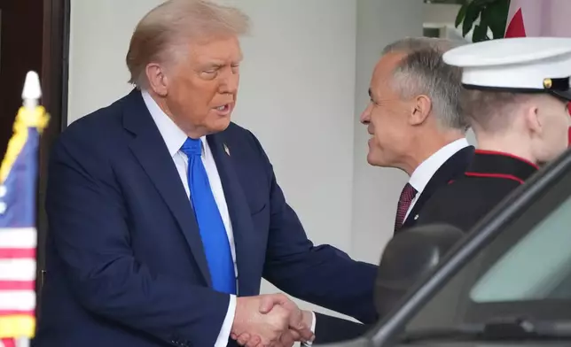 President Donald Trump greets Canada's Prime Minister Mark Carney, as he arrives at the White House, Tuesday, Oct. 7, 2025, in Washington. (AP Photo/Jacquelyn Martin)