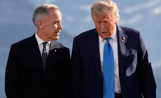 FILE - Canada's Prime Minister Mark Carney talks with President Donald Trump before a group photo at the G7 Summit, June 16, 2025, in Kananaskis, Canada. (AP Photo/Mark Schiefelbein, File)