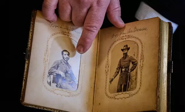 Portraits of Mass. Rep. Charles Lewis Mitchell, left, and Dr. John V. de Grasse are shown from an photograph album from the personal collection of anti-slavery activist Harriet Hayden, which was printed in the 1860's, at the Boston Athenaeum, Thursday, Oct. 9, 2025, in Boston. (AP Photo/Charles Krupa)