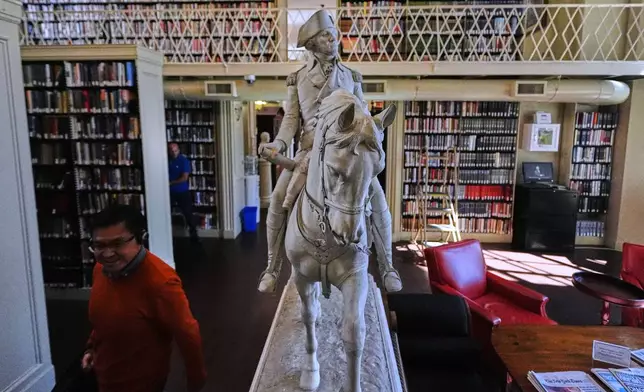 A statue of George Washington on horseback is displayed in the private library at the Boston Athenaeum, Thursday, Oct. 9, 2025, in Boston. (AP Photo/Charles Krupa)