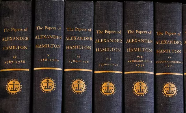 Bound copies of Alexander Hamilton's papers are displayed on a shelf at the Boston Athenaeum, a private library, Thursday, Oct. 9, 2025, in Boston. (AP Photo/Charles Krupa)