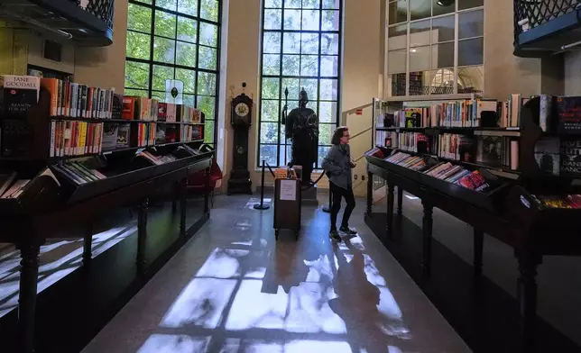 A visitor browses recent publications at the Boston Athenaeum, a private library, Thursday, Oct. 9, 2025, in Boston. (AP Photo/Charles Krupa)