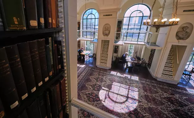 Guests read and work at the fifth-floor reading room, designated a "silent space", at the Boston Athenaeum, Thursday, Oct. 9, 2025, in Boston. (AP Photo/Charles Krupa)