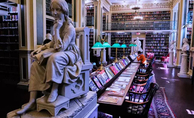 Little Nell, left, a sculpture of the character from Charles Dickens's "The Old Curiosity Shop", is displayed at the Boston Athenaeum, Thursday, Oct. 9, 2025, in Boston. (AP Photo/Charles Krupa)