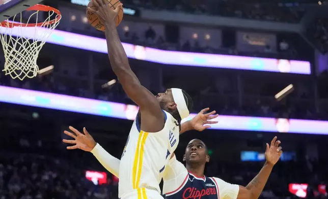 Golden State Warriors guard Buddy Hield, left, shoots against Los Angeles Clippers guard Chris Paul during the first half of an NBA basketball game in San Francisco, Tuesday, Oct. 28, 2025. (AP Photo/Jeff Chiu)
