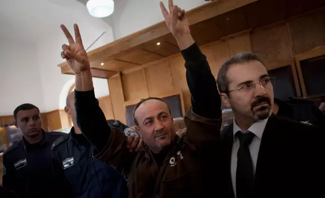 FILE - Senior Fatah leader Marwan Barghouti makes the victory sign in front of the media during his arrival to testify in a trial at a Jerusalem court, Jan. 25, 2012. (AP Photo/Bernat Armangue, File)
