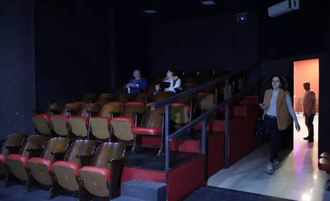 People waiting for a movie to start at the Cine LT3 built in an old parking garage in Sao Paulo, Thursday, Oct. 9, 2025. (AP Photo/Ettore Chiereguini)