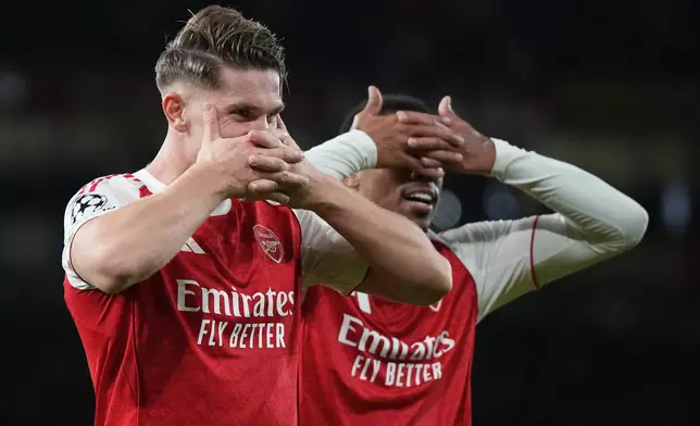 Arsenal's Viktor Gyoekeres, left, celebrates with Arsenal's Gabriel after scoring his side's third goal during the Champions League opening phase soccer match between Arsenal and Atletico Madrid in London, England, Tuesday, Oct. 21, 2025. (AP Photo/Alastair Grant)